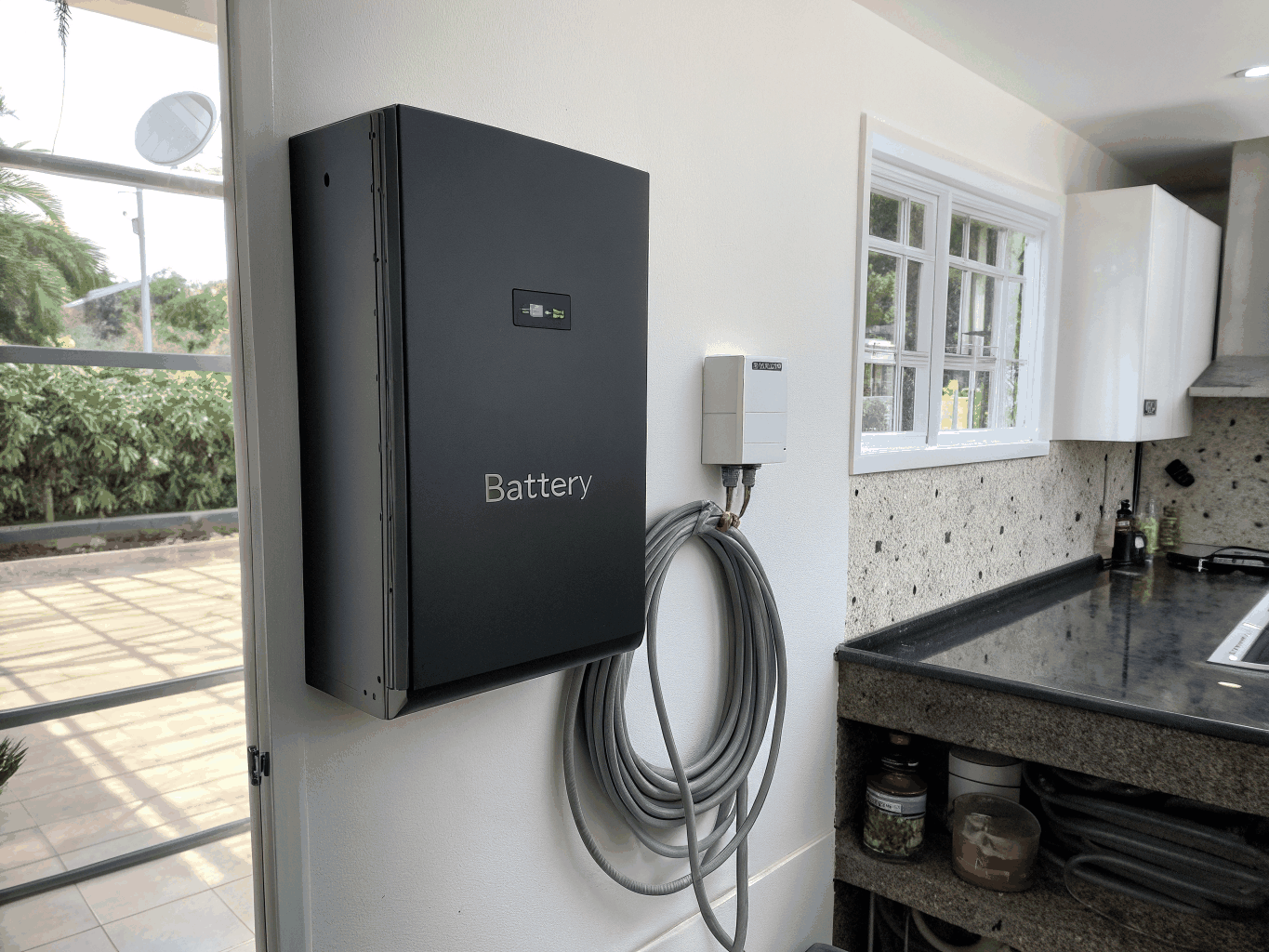 Fox ESS modular high-voltage home battery installed on a garage wall